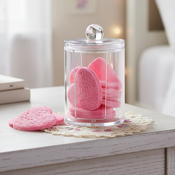 Glass jar with pink heart-shaped makeup remover spnges